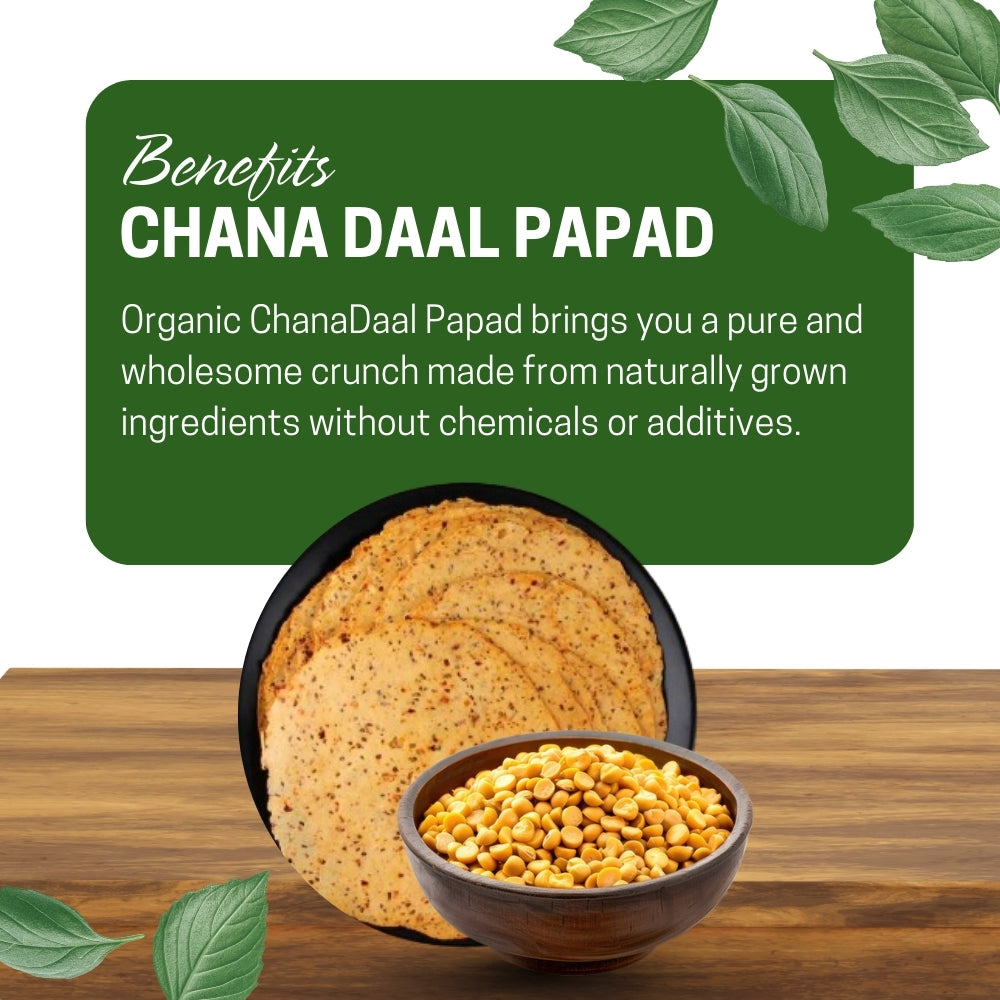 Chana Daal Papad with a bowl of chana, on a wooden surface, surrounded by green leaves.