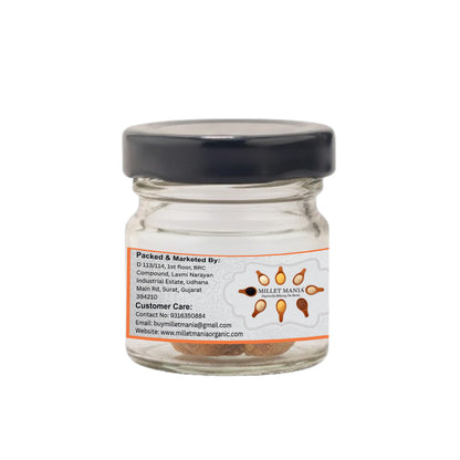 Glass jar with a black lid and a label on a white background